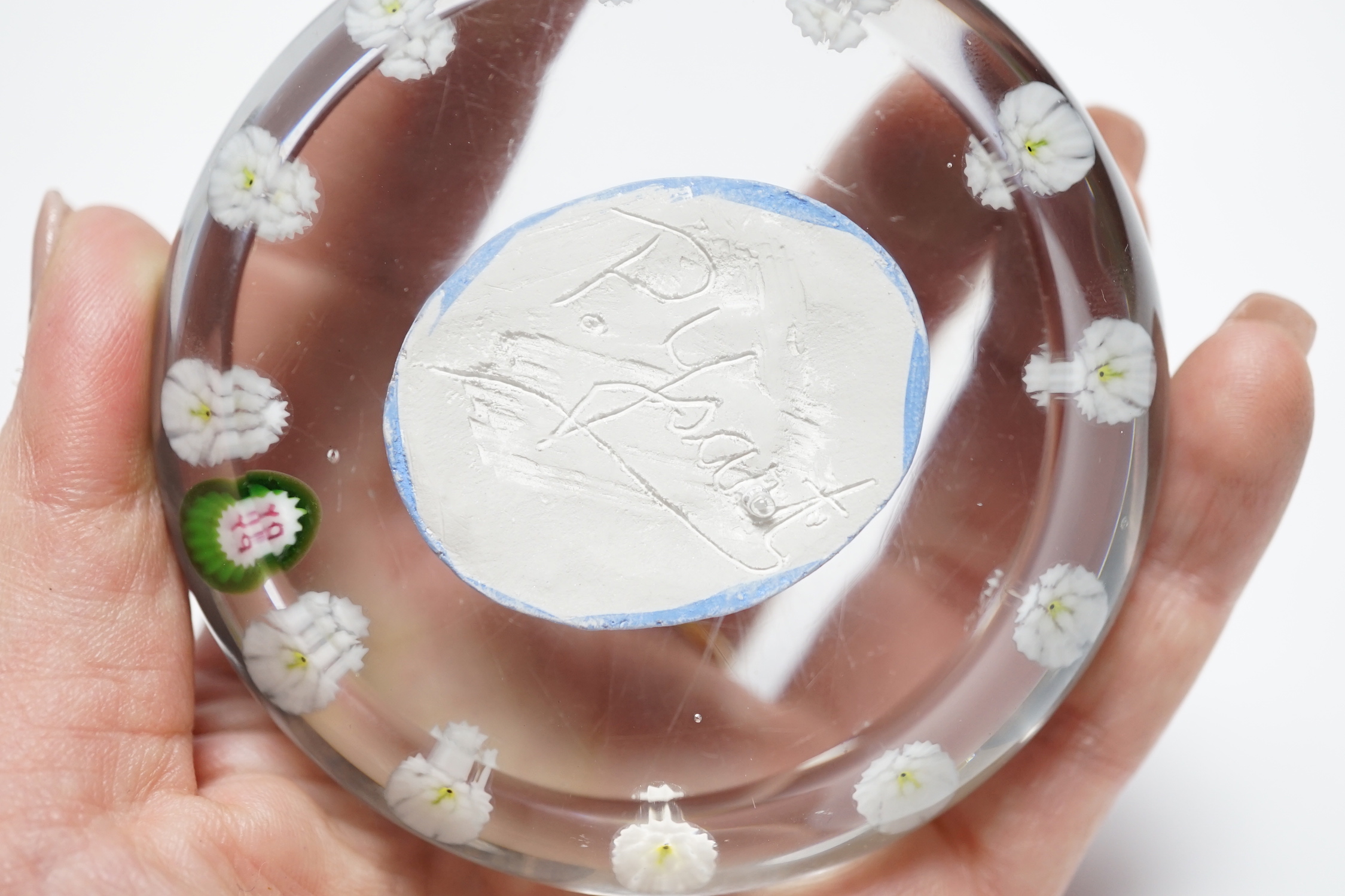 A rare Paul Ysart ‘Grecian Head’ sulphide portrait glass paperweight, ‘PY’ cane, the sulphide plaque of a lady with ‘P. Ysart’ signature to the reverse, 8cm diameter, together with a glass cameo effect brooch from which